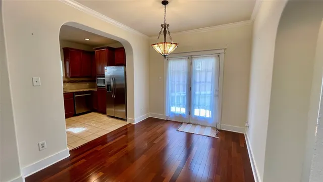 a view of a dining room with furniture wooden floor and chandelier