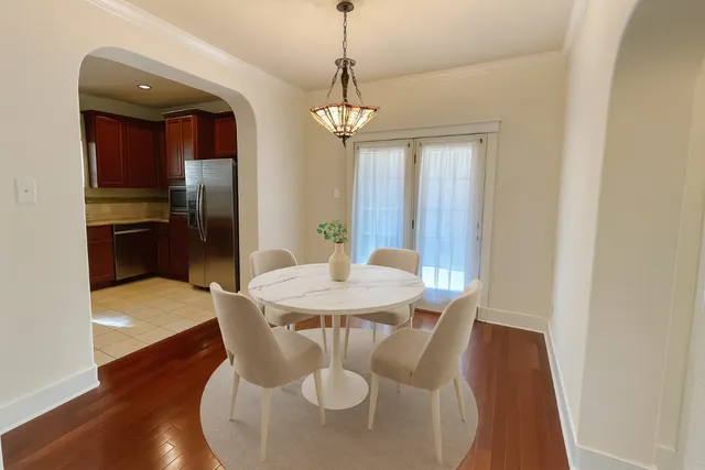 a view of kitchen and hall with wooden floor