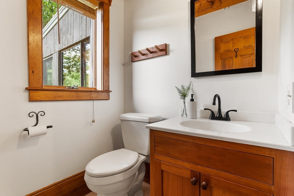 292 Berlin Road Bolton, MA 01740 - Photo 17 of 42 a bathroom with a toilet sink and mirror
