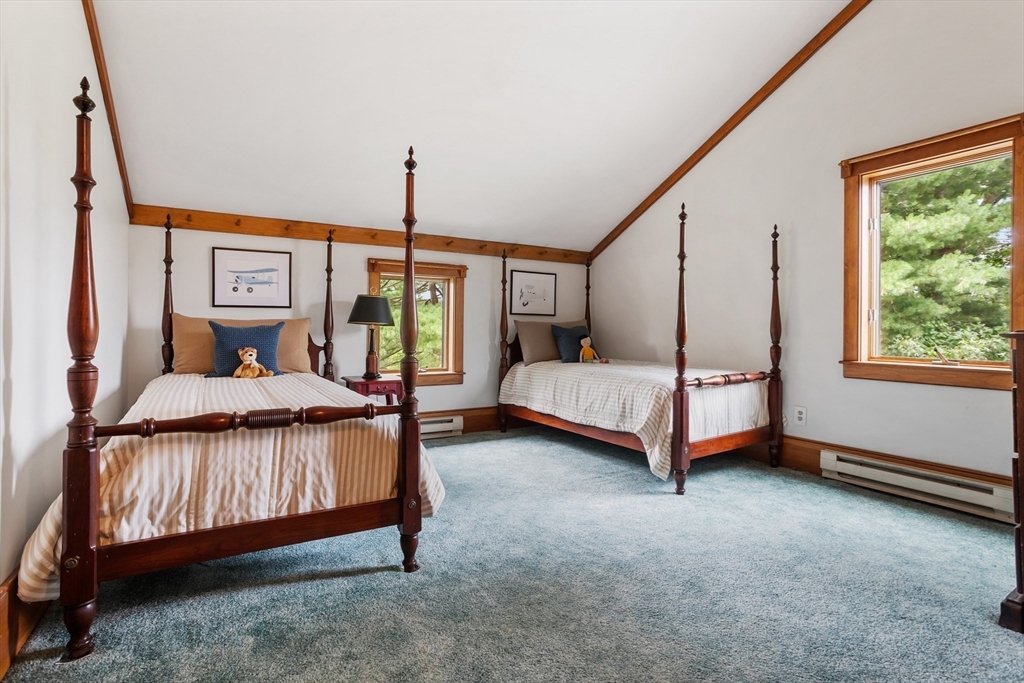 292 Berlin Road Bolton, MA 01740 - Photo 26 of 42 a bedroom with a bed and a chandelier