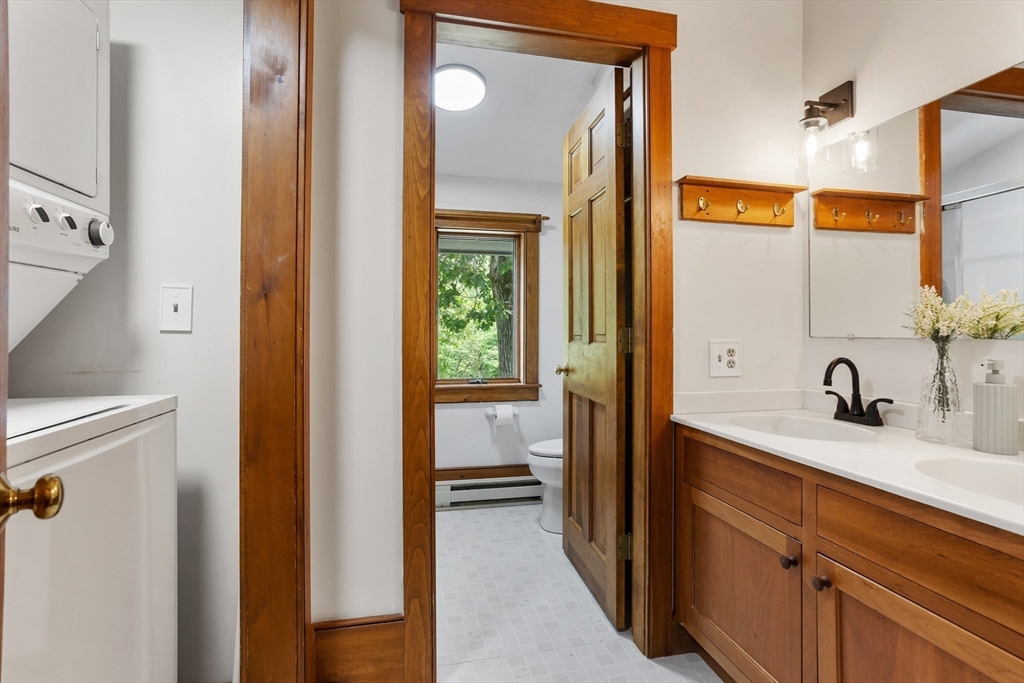 292 Berlin Road Bolton, MA 01740 - Photo 29 of 42 a en suite bathroom with a granite countertop sink and a mirror