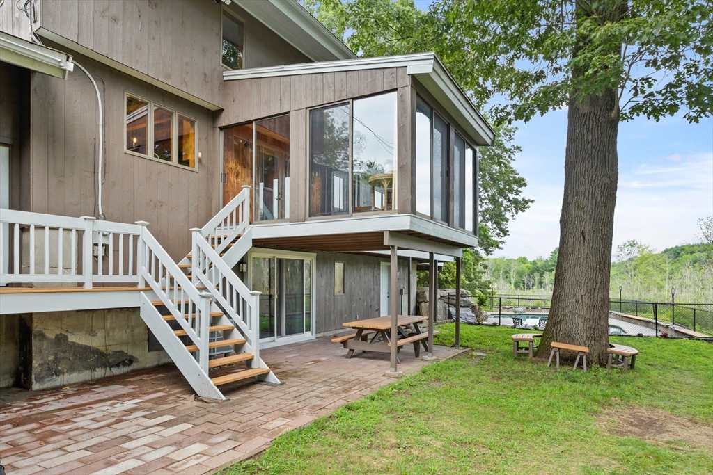 292 Berlin Road Bolton, MA 01740 - Photo 3 of 42 a view of a house with backyard porch and sitting area