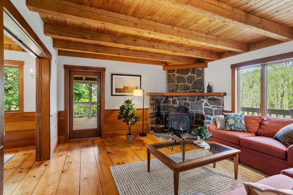 292 Berlin Road Bolton, MA 01740 - Photo 4 of 42 a living room with furniture a fireplace and a table