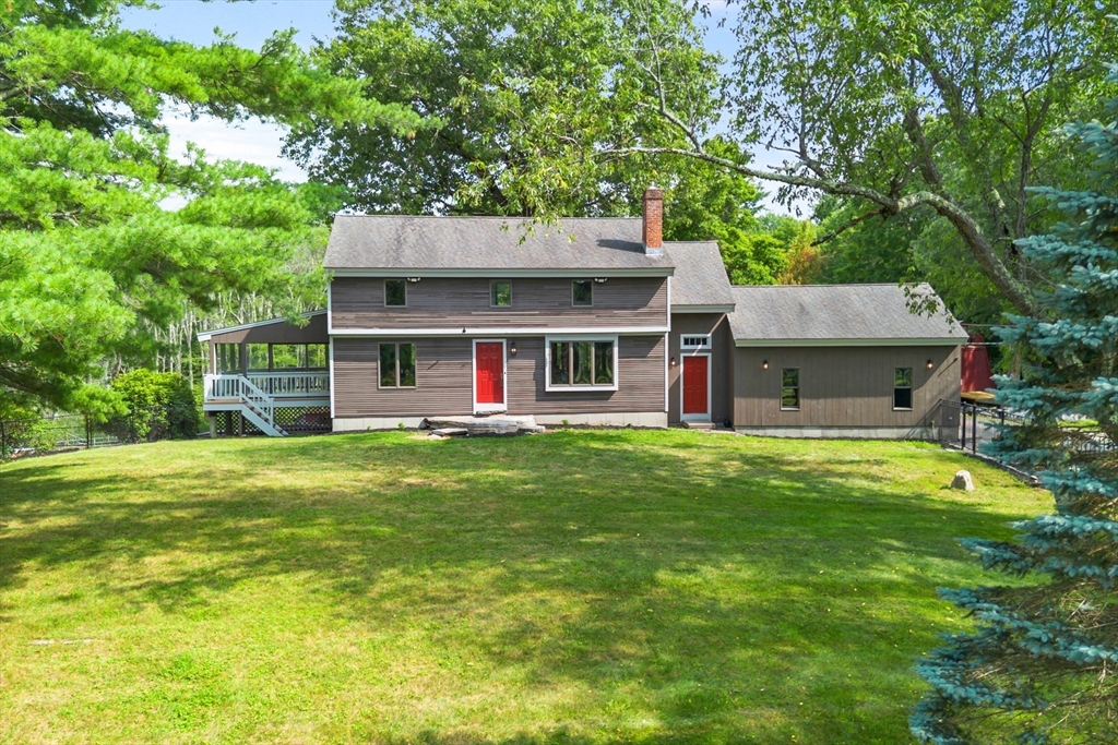 292 Berlin Road Bolton, MA 01740 - Photo 42 of 42 a front view of a house with a garden and deck