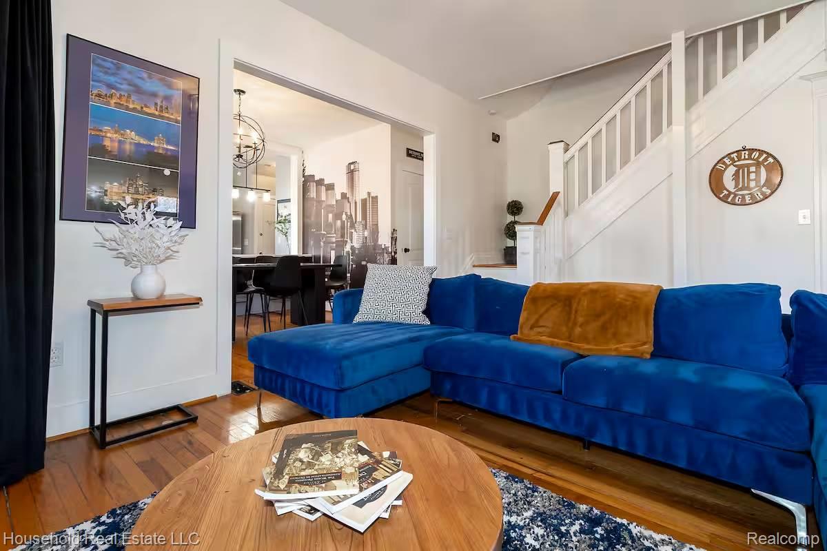 4446 Commonwealth Street Detroit, MI 48208 - Photo 25 of 28 Living room with wood-type flooring and a chandelier