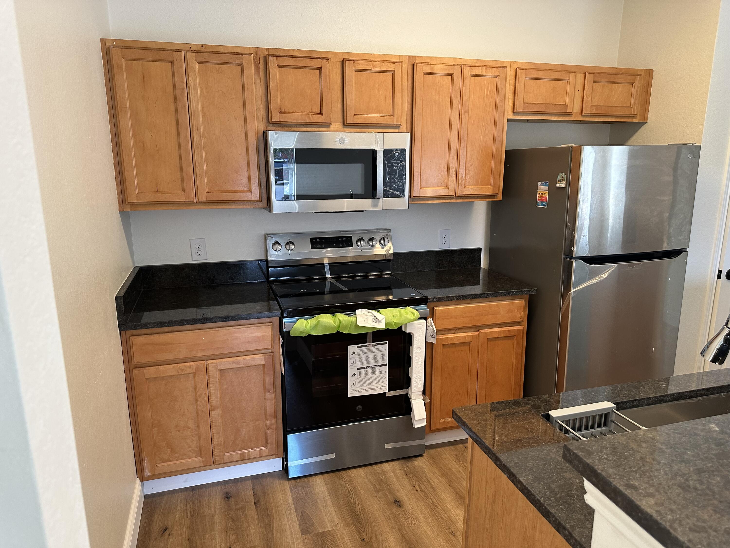 1150 Airport Road, Unit 138 Destin, FL 32541 - Photo 4 of 16 a kitchen with stainless steel appliances a stove a microwave and a refrigerator