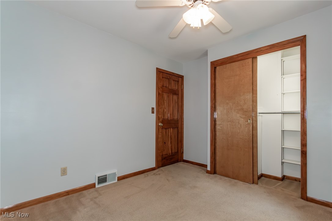5223 Edenhurst Road Cleveland, OH 44124 - Photo 10 of 50 Unfurnished bedroom with light carpet, a closet, and ceiling fan