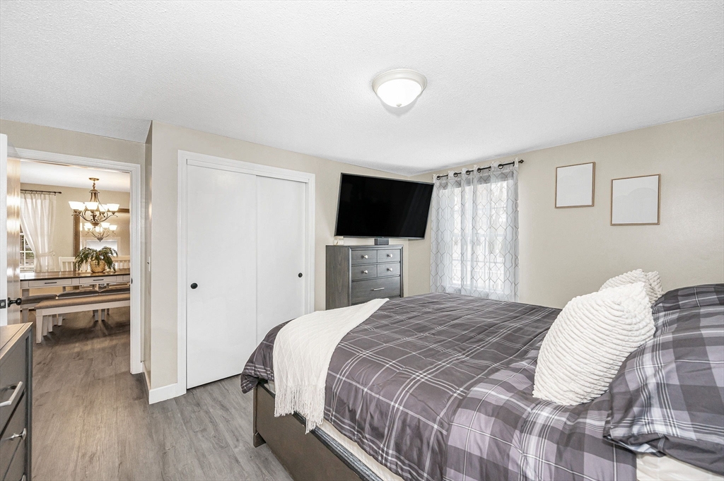 16 Old Lowell Road Westford, MA 01886 - Photo 12 of 41 a bedroom with a bed and a flat screen tv