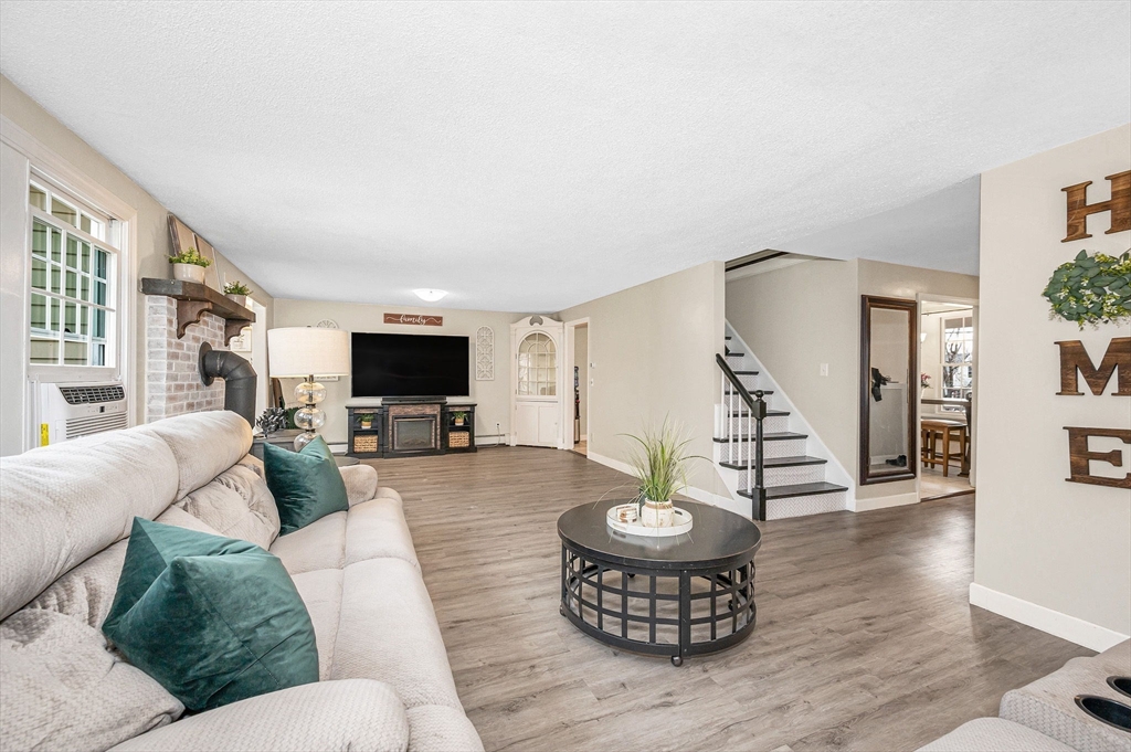 16 Old Lowell Road Westford, MA 01886 - Photo 14 of 41 a living room with furniture and a flat screen tv