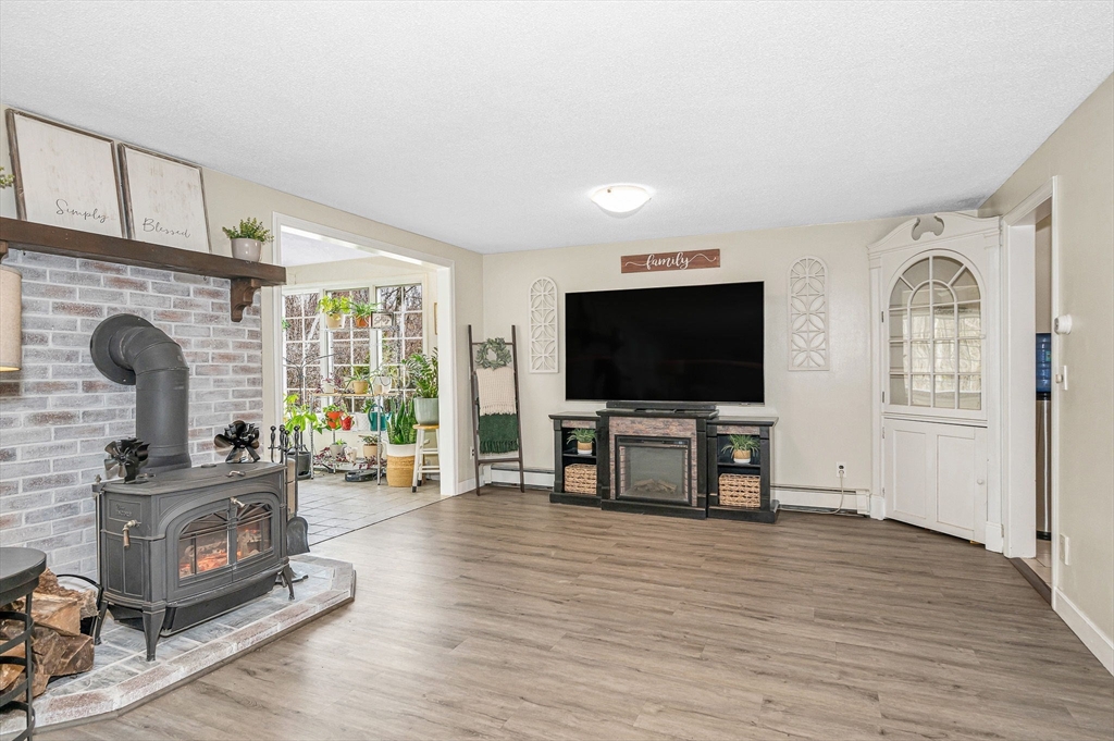 16 Old Lowell Road Westford, MA 01886 - Photo 17 of 41 a living room with furniture and a flat screen tv