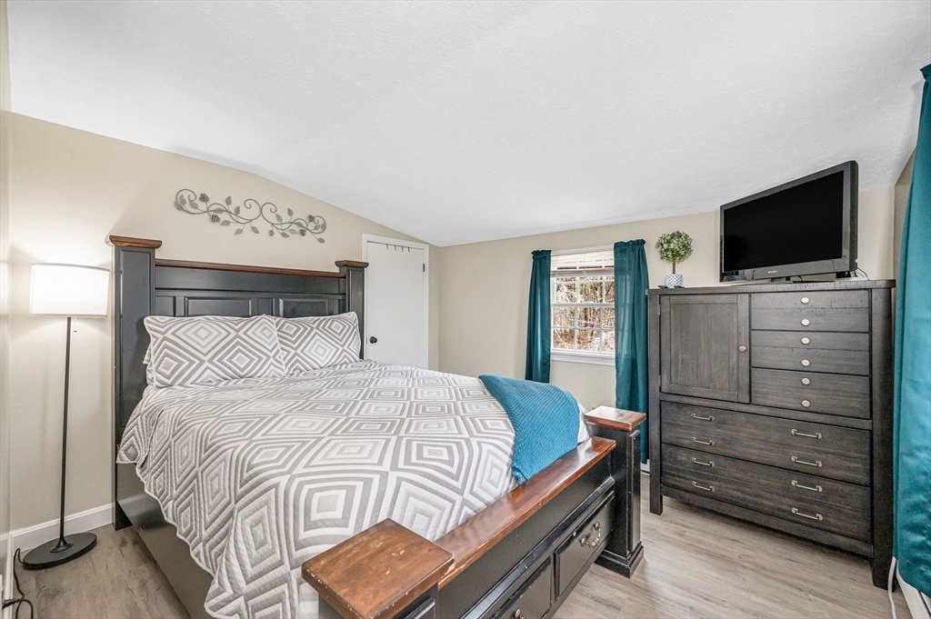 16 Old Lowell Road Westford, MA 01886 - Photo 20 of 41 a bedroom with a bed and flat screen tv