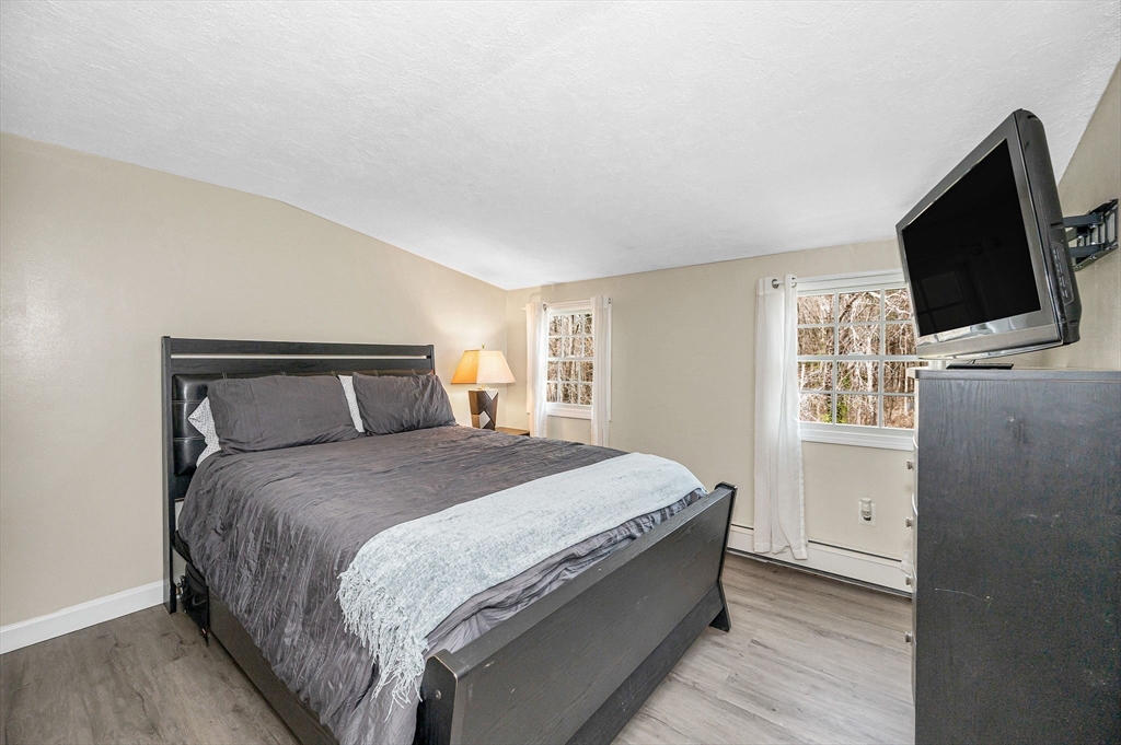 16 Old Lowell Road Westford, MA 01886 - Photo 21 of 41 a bedroom with a bed and a flat screen tv