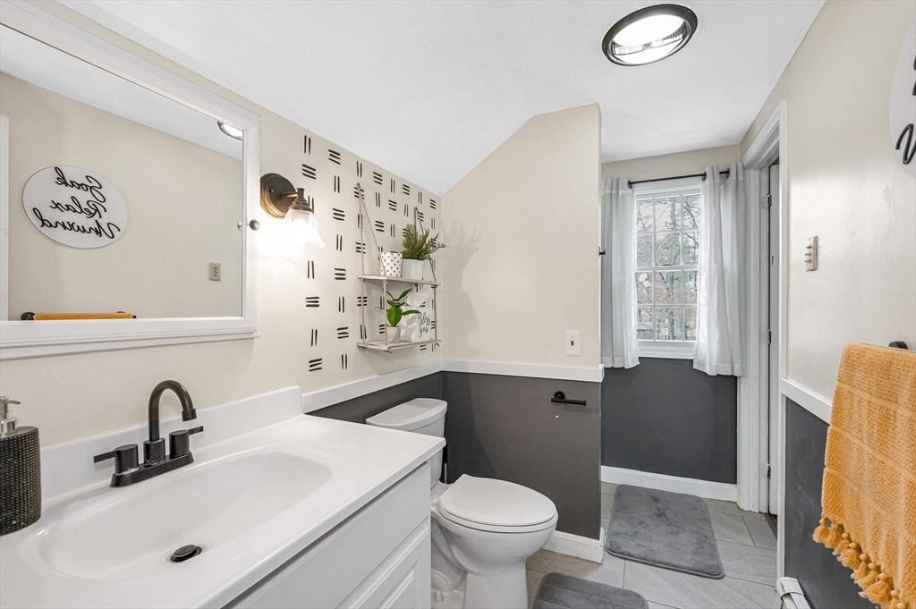 16 Old Lowell Road Westford, MA 01886 - Photo 23 of 41 a bathroom with a sink a toilet and shower curtain