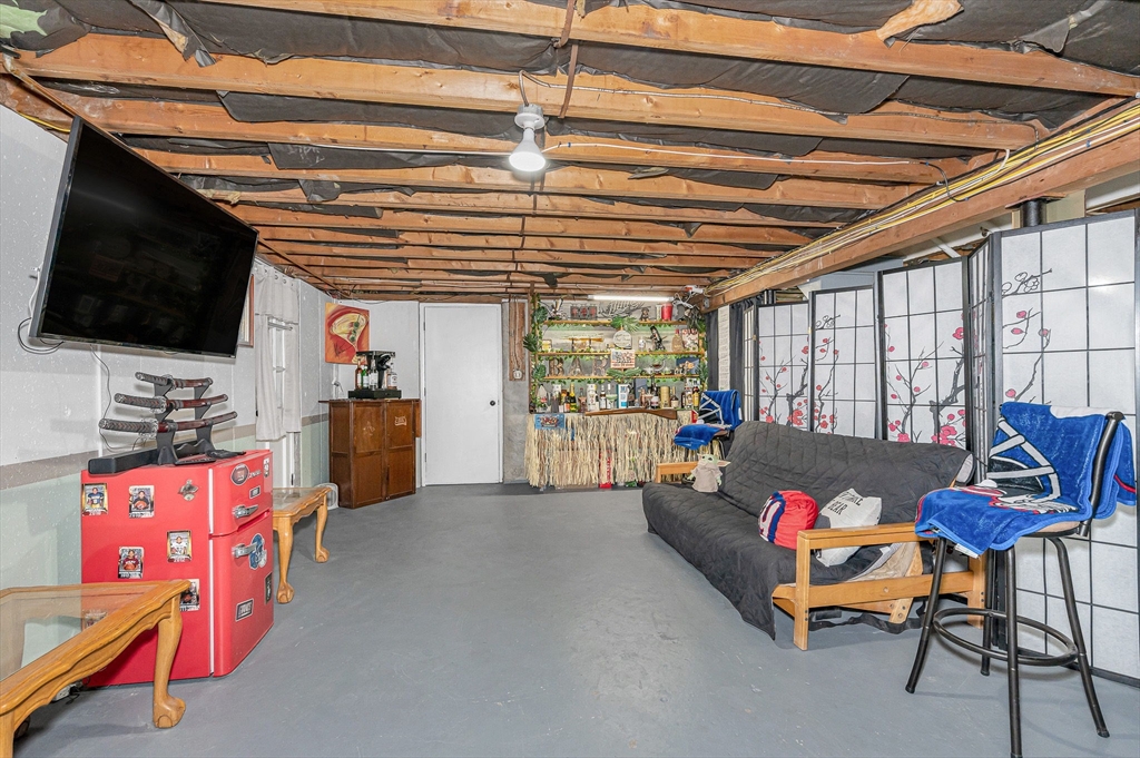 16 Old Lowell Road Westford, MA 01886 - Photo 26 of 41 a living room with furniture and a flat screen tv