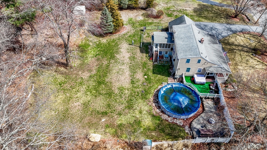 16 Old Lowell Road Westford, MA 01886 - Photo 37 of 41 an aerial view of a house with garden space and sitting space