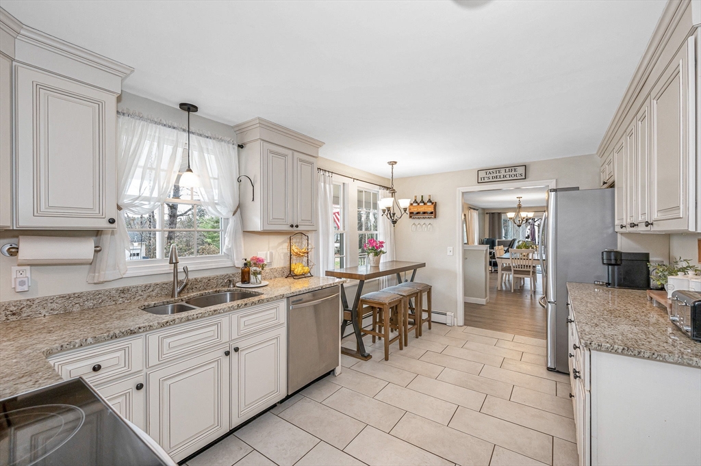 16 Old Lowell Road Westford, MA 01886 - Photo 6 of 41 a kitchen with granite countertop sink cabinets and stainless steel appliances