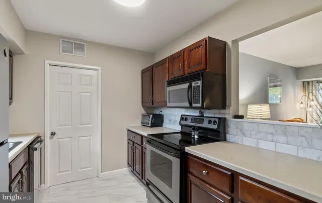 a kitchen with a sink and a stove top oven