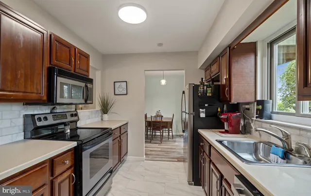 a kitchen that has a sink and a stove