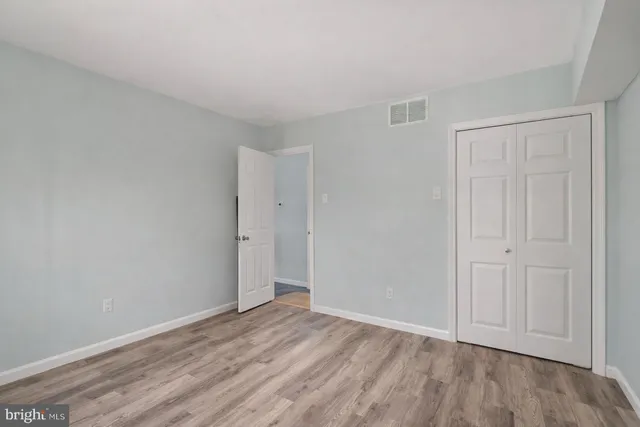 a view of an empty room and wooden floor