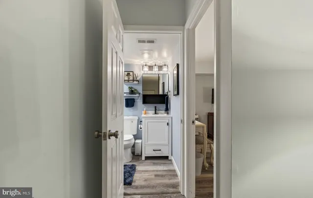 a bathroom with a glass door shower and sink