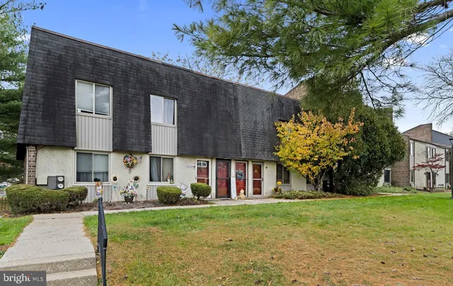 a view of a house with backyard and a tree