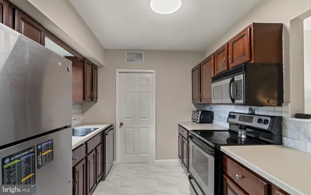 a kitchen with a sink stove and microwave