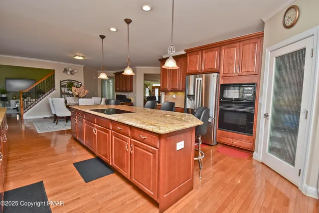 a room with pool table flat screen tv and windows