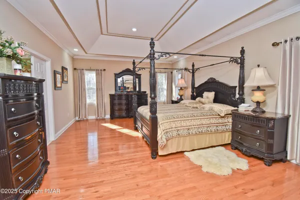 a bed sitting in a bedroom next to a larger window