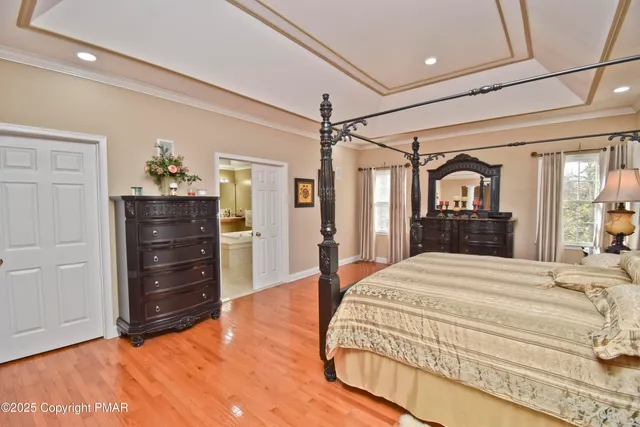 a bedroom with a bed and a potted plant
