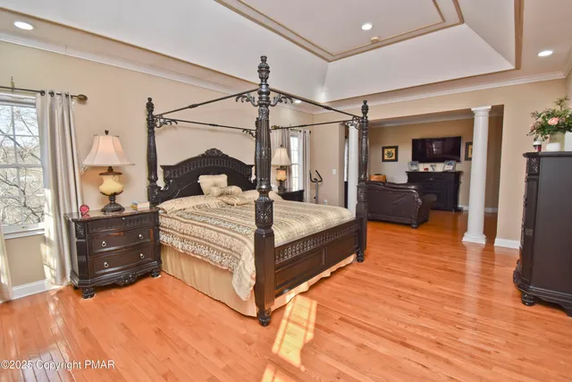 a bathroom with a toilet a sink a mirror and a window