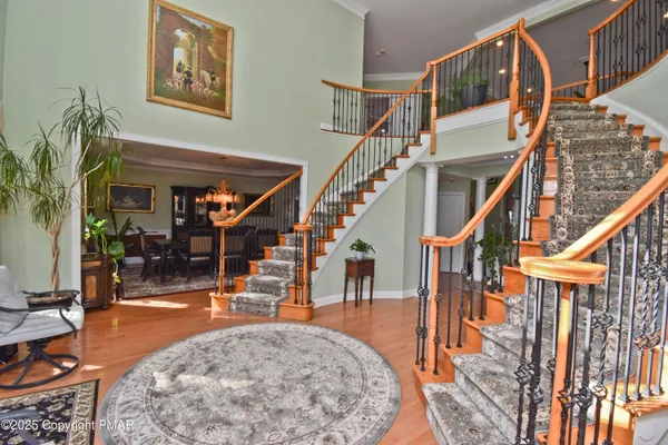 a dining room with furniture a chandelier and wooden floor