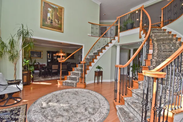a dining room with furniture a chandelier and wooden floor