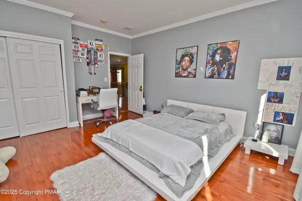 a view of a garden with trees and buildings in the background