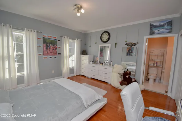 an aerial view of a house with a yard and lake view