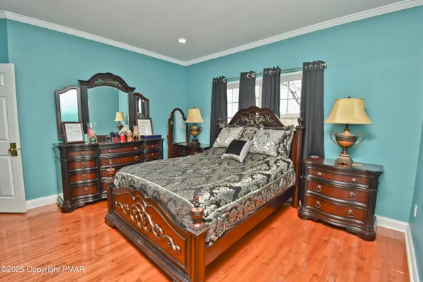 an aerial view of a house with a yard basket ball court and outdoor seating