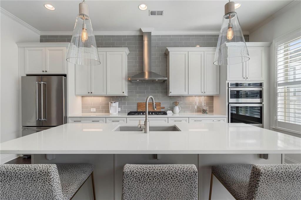 1076 Heyward Way Alpharetta, GA 30009 - Photo 11 of 57 a kitchen with stainless steel appliances granite countertop a sink refrigerator and cabinets