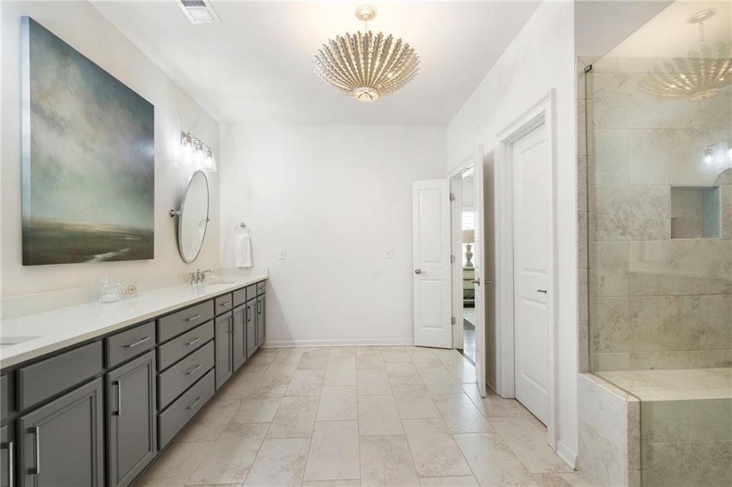 1076 Heyward Way Alpharetta, GA 30009 - Photo 20 of 57 a bathroom with a sink a mirror and a bathtub