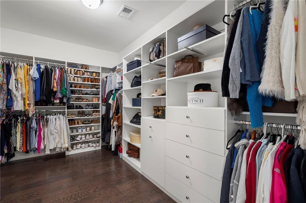 1076 Heyward Way Alpharetta, GA 30009 - Photo 22 of 57 a view of walk in closet with clothes and shoes