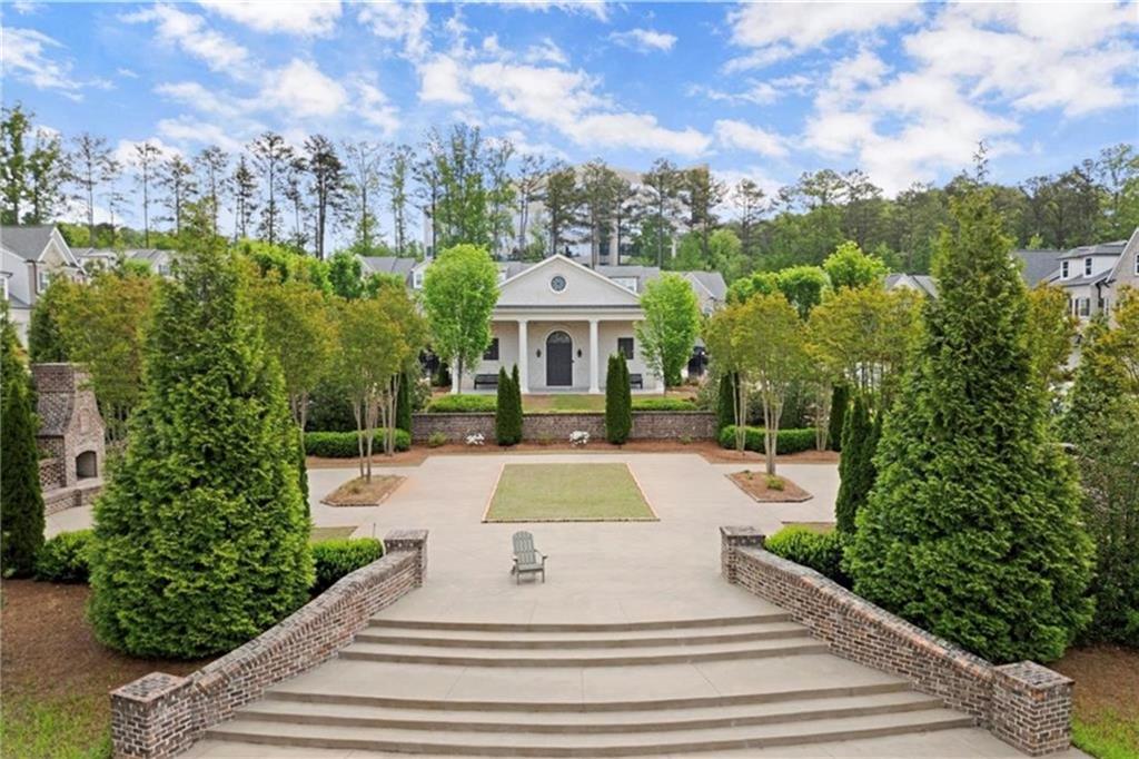 1076 Heyward Way Alpharetta, GA 30009 - Photo 30 of 57 a view of a white house with a yard plants and large tree