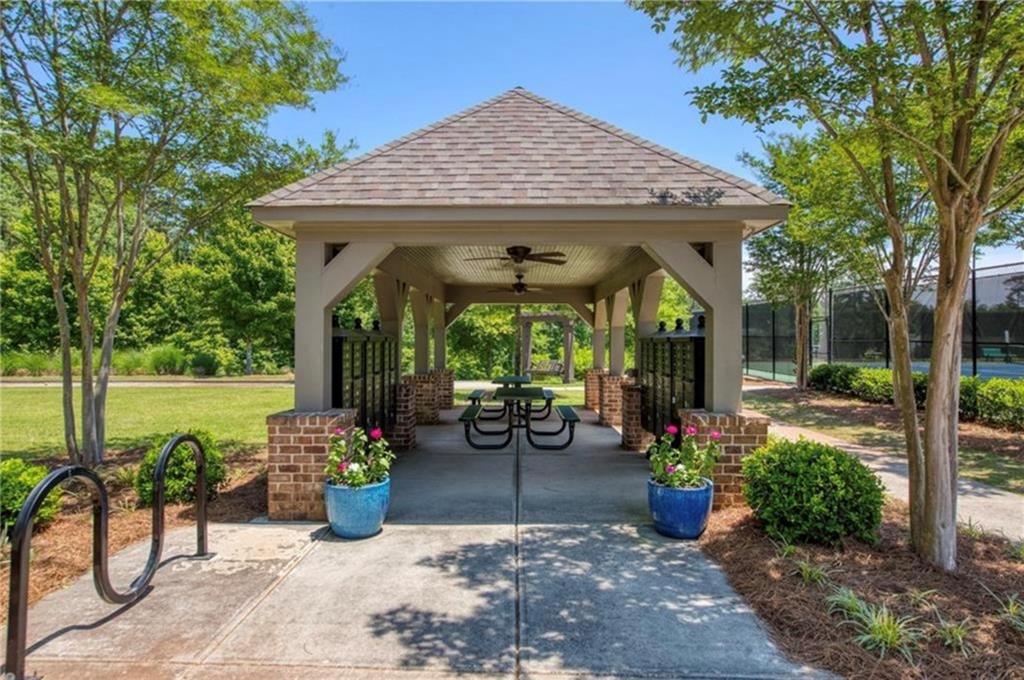 1076 Heyward Way Alpharetta, GA 30009 - Photo 34 of 57 a view of a patio with table and chairs potted plants and large tree