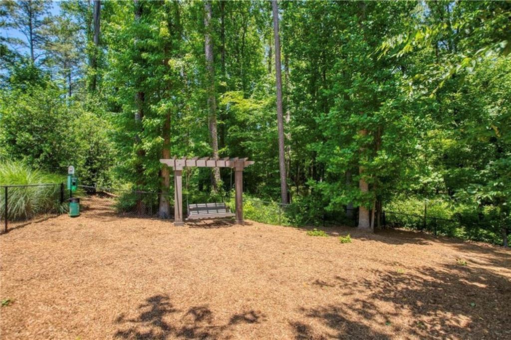 1076 Heyward Way Alpharetta, GA 30009 - Photo 37 of 57 a backyard of a house with lots of green space and fountain