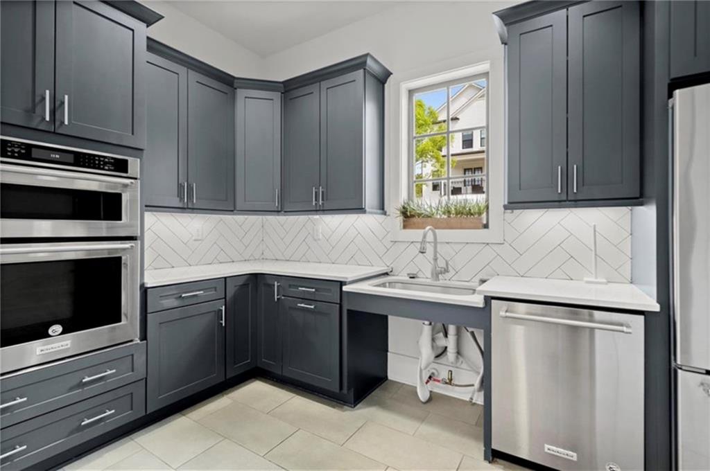 1076 Heyward Way Alpharetta, GA 30009 - Photo 44 of 57 a kitchen with a sink stove and cabinets