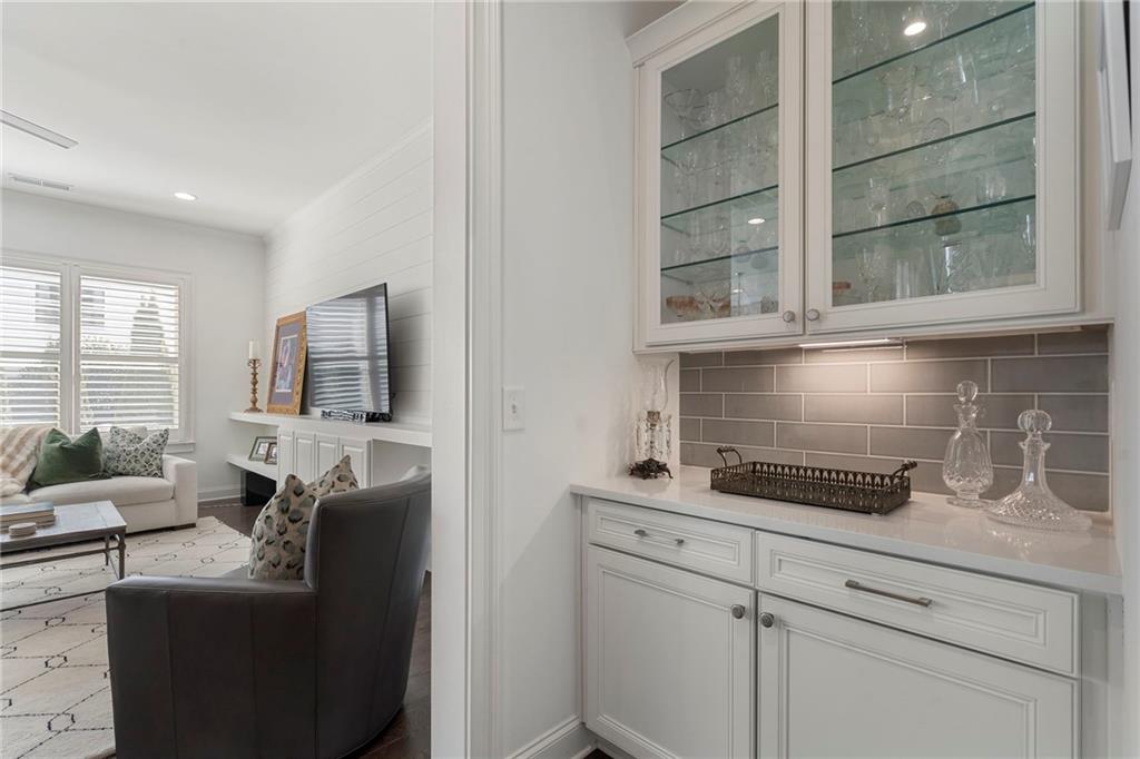 1076 Heyward Way Alpharetta, GA 30009 - Photo 8 of 57 a living room with furniture and a flat screen tv