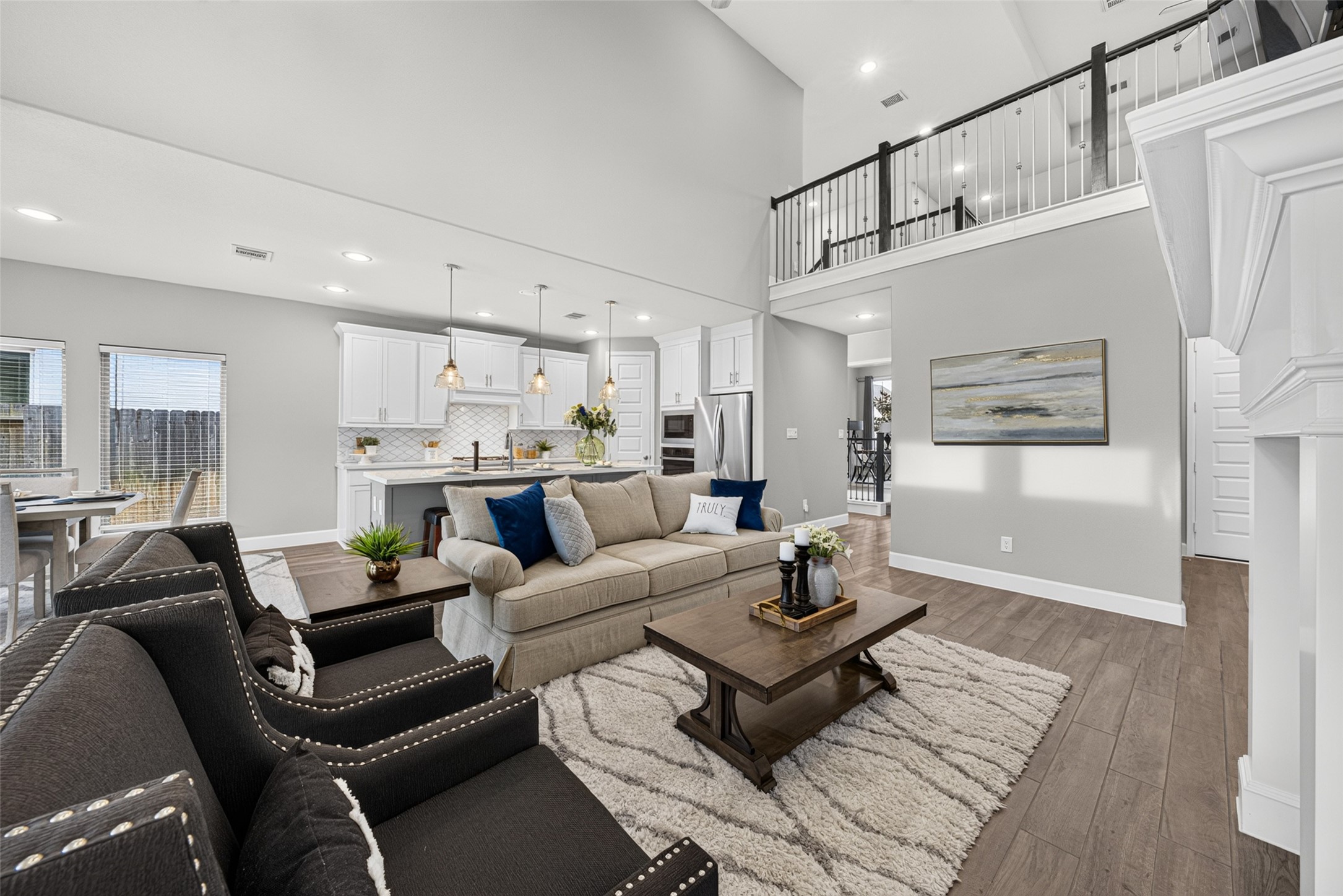 4207 Ana Ridge Lane Fulshear, TX 77441 - Photo 7 of 37 Stylish living space showcasing high ceilings and modern finishes, designed for effortless entertaining and everyday family comfort.