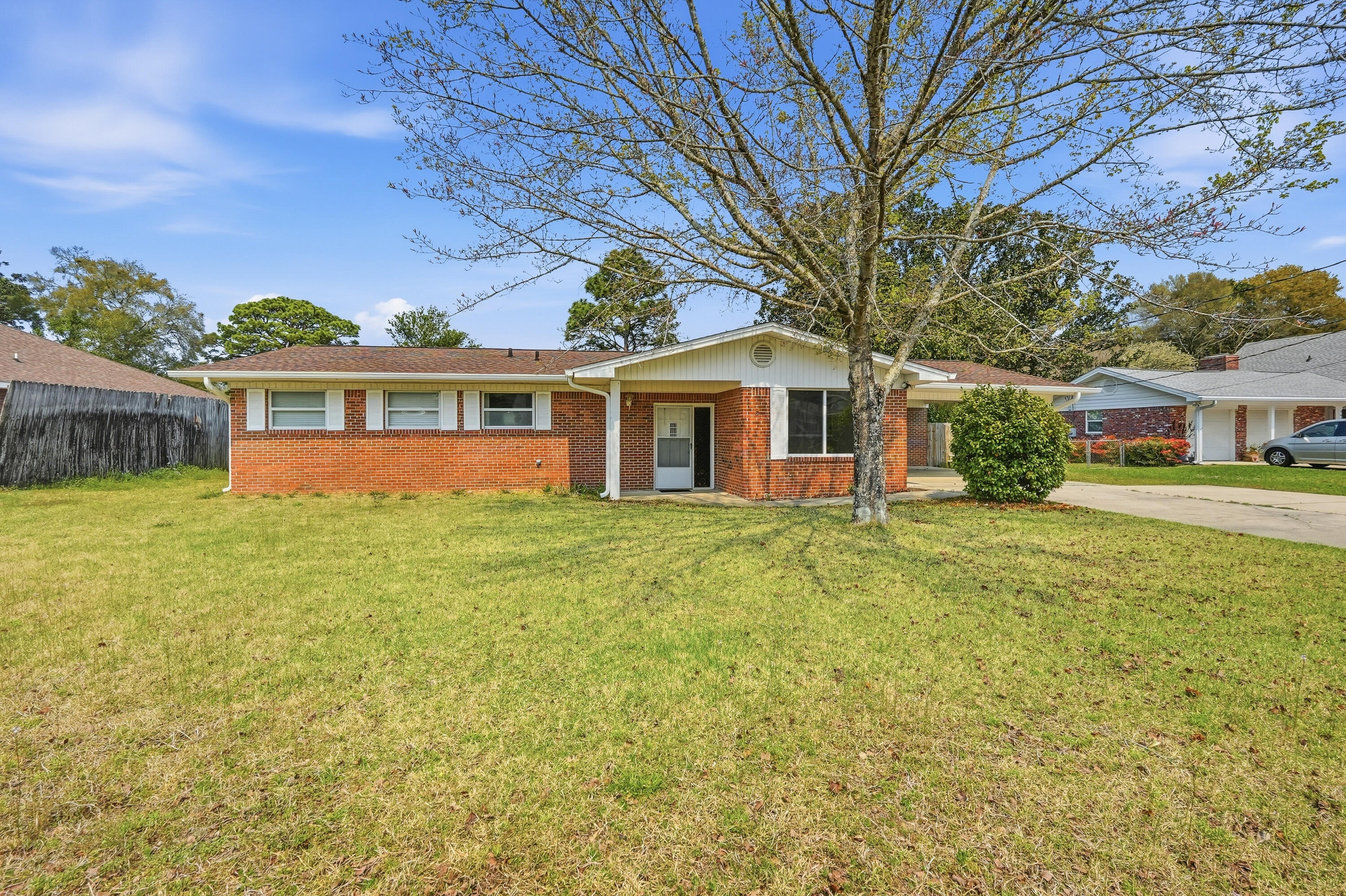 15 Maple Avenue Shalimar, FL 32579 - Photo 6 of 45 a front view of a house with a garden and lake view