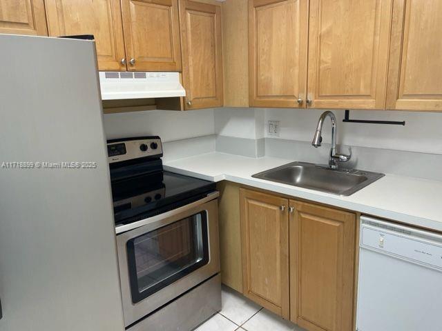 Fountainebleau Miami, FL 33172 - Photo 4 of 18 a kitchen with granite countertop a sink stainless steel appliances white cabinets and a window