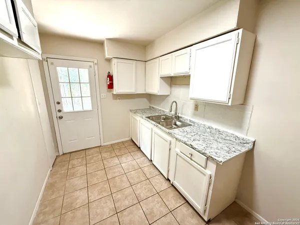 a kitchen with a sink stove and cabinets