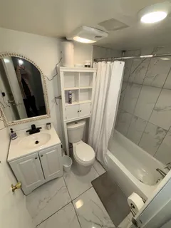 a bathroom with a toilet sink and mirror