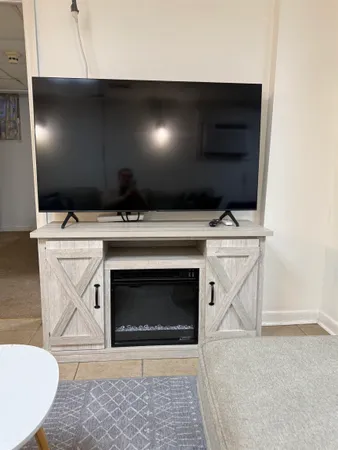 a living room with a fireplace furniture and a rug
