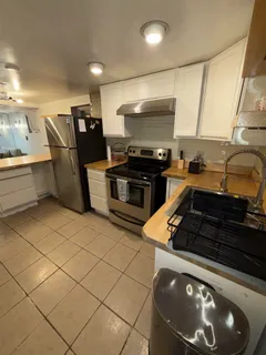 a kitchen with a stove and a refrigerator